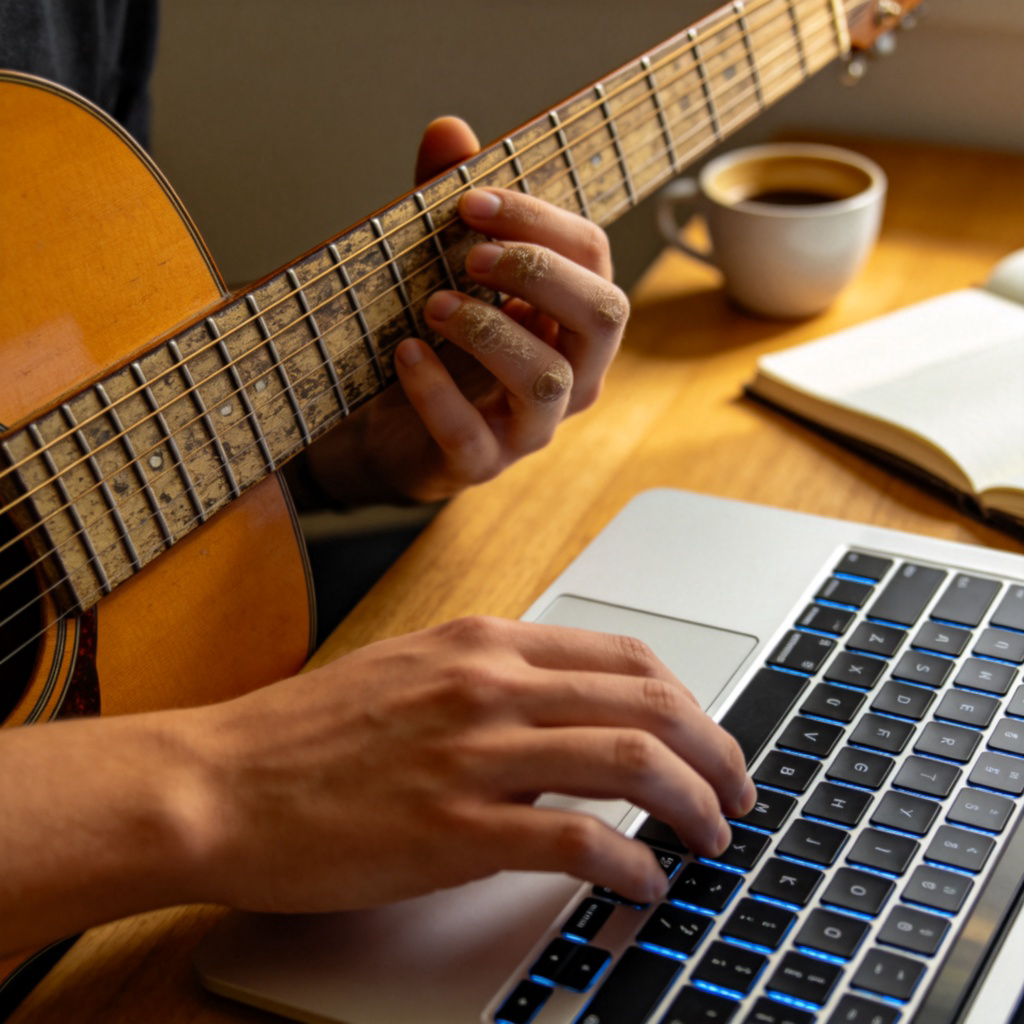 Close-up shot of a person's hands practicing a skill, like playing guitar chords or typing code on a laptop keyboard. The foreground shows hands in action, the background is slightly blurred and simple. Focus on progress and learning.